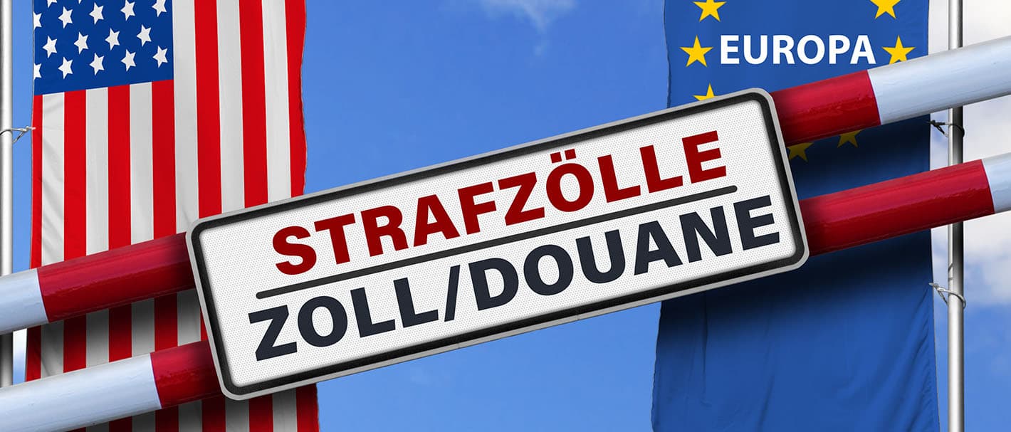 Two barriers bearing the inscription “Punitive Tariffs, Customs” against the backdrop of the European and American flags.